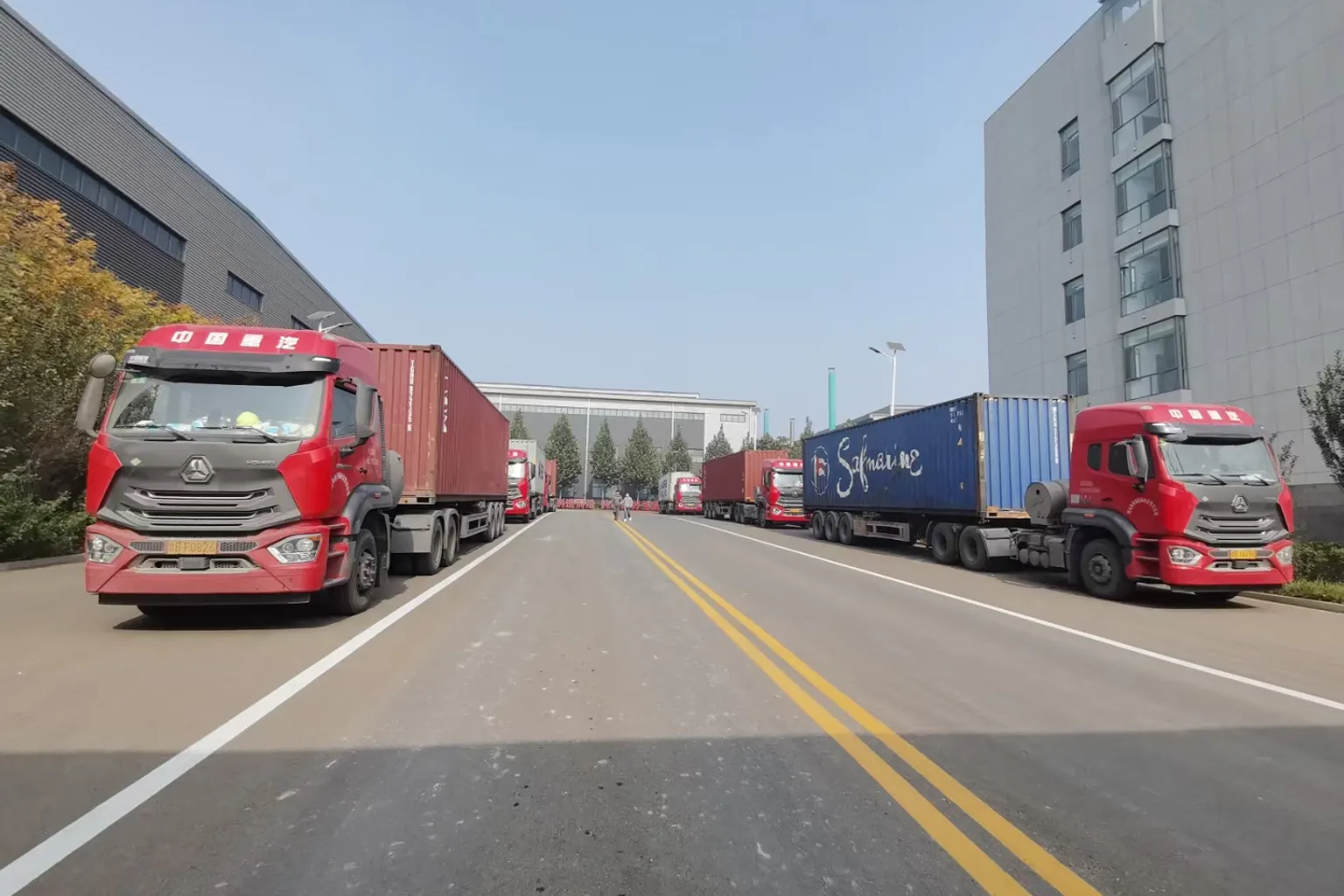 Container trucks at the NEOO factory loading dock